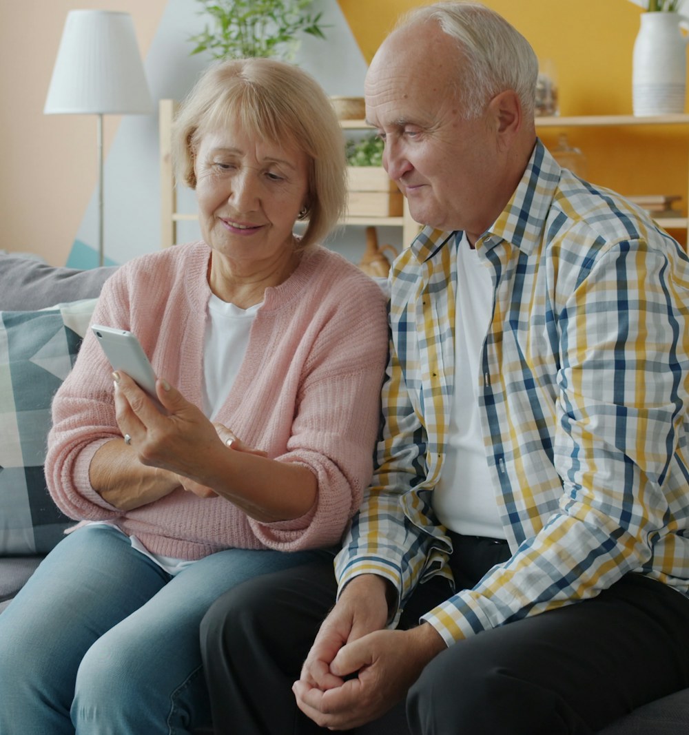Senior couple smiling at a smartphone together